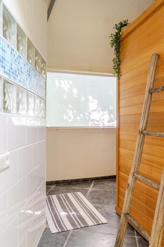 a ladder in a bathroom with a window at Unique private guesthouse 'The Iglo' in Paterswolde