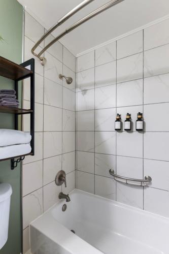 a bathroom with a shower with a white tub at Downtown Nashville Riverfront Unit 820 in Nashville