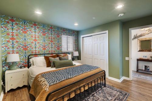 a bedroom with a bed and a colorful wall at Downtown Nashville Riverfront Unit 820 in Nashville