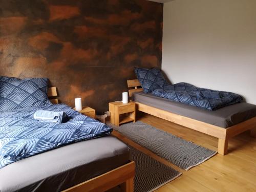 a bedroom with two beds and a wall at Ferienwohnung "Tilda" auf Hof Elseblick in Bünde