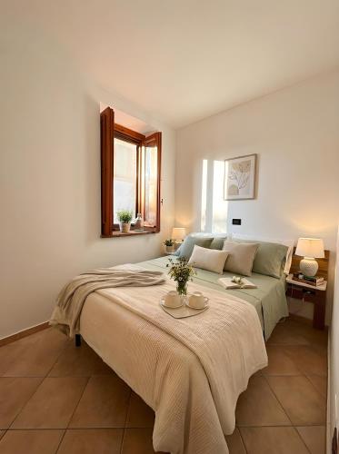 a bedroom with a bed with a table on it at Attico con vista unica in Scalea