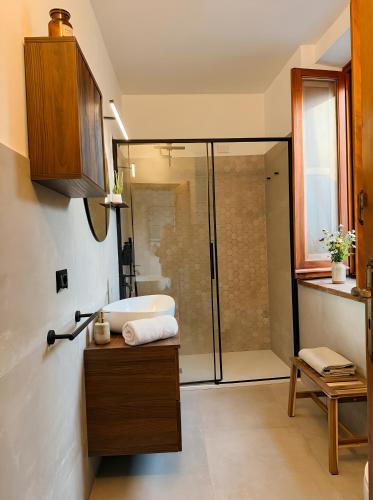 a bathroom with a shower and a sink and a tub at Attico con vista unica in Scalea