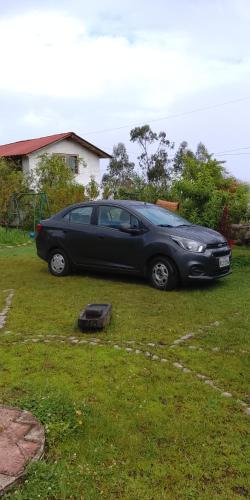 a black car parked in a yard at Farmstay in Ibarra
