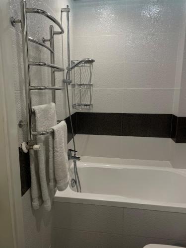 bagno con vasca e asciugamani di Spacious apartment with a beautiful view a Căuşeni