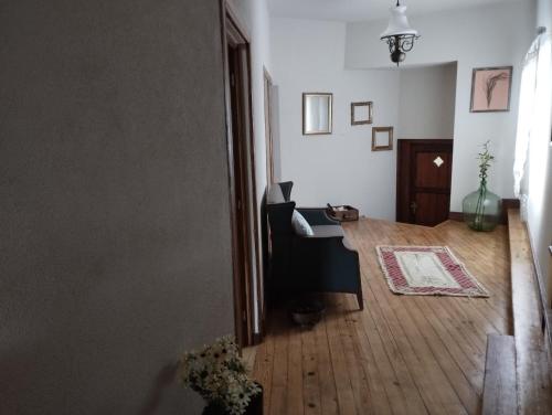 a living room with a table and a chair at 3HOUSE Sol na Eira em Paredes in Rebordosa