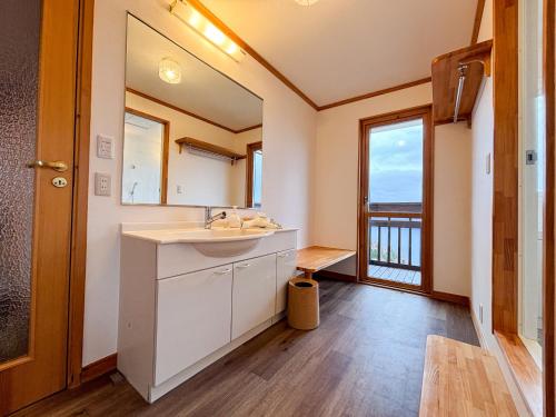 a bathroom with a sink and a large window at Cloud9 Toya in Lake Toya