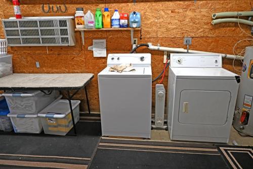 a kitchen with two washers and a stove and a counter at Hotel Oasis with Outdoor Kitchen in Fall River