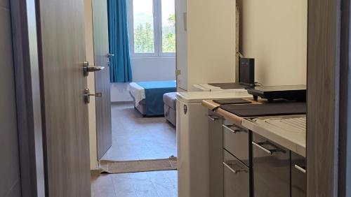 a small room with a kitchen with a window at Zero Distance Studio in Podgorica