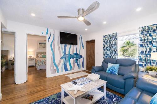 a living room with a blue couch and a tv at 400 South - Unit G in Cocoa Beach