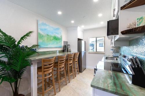 a kitchen with a counter and a bar with stools at 400 South - Unit G in Cocoa Beach