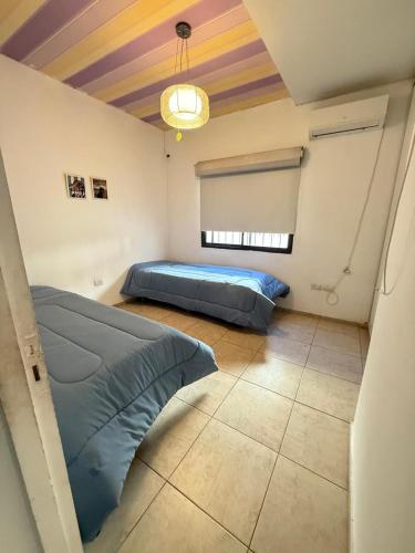 a bedroom with a bed and a colorful ceiling at summer house in La Porteña