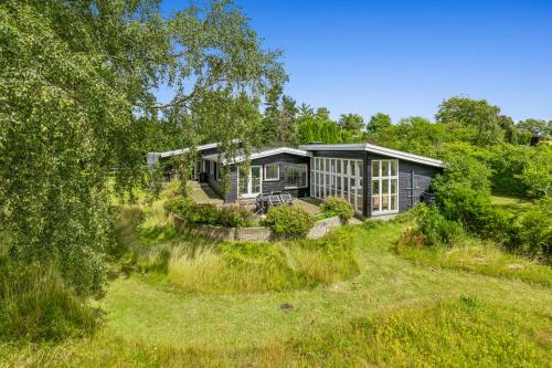 a house in the middle of a field at Sunset over water, 50 mins from Copenhagen in Skibby