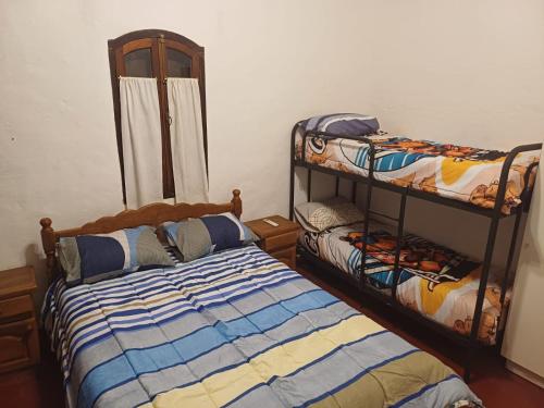 En eller flere senge i et værelse på Oasis casa Paso de la patria, Corrientes, Argentina