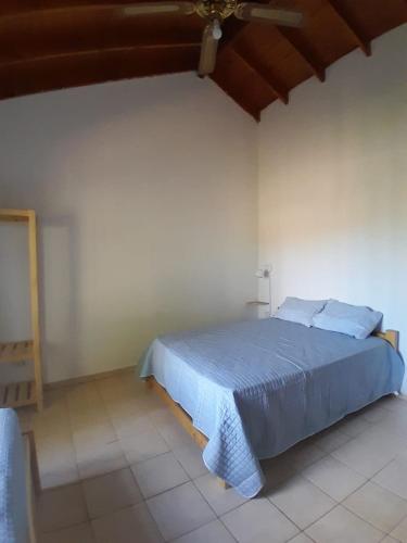 a bedroom with a blue bed in a room at Casa Las Marías in General Belgrano