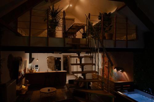 a room with a spiral staircase in a house at Loft avec Spa Privatif in Frameries