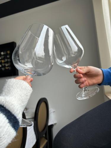 two people holding wine glasses in their hands at Minho AL in Paredes de Coura