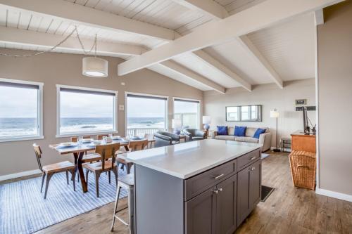 a kitchen and living room with a table and chairs at Sea-Esta in Lincoln City