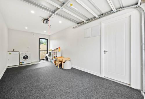a room with white walls and a large door at Bright Home Travel Service at Mt Albert in Auckland