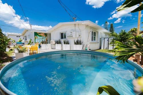 a large blue pool in front of a house at The Juni-7 Unit Renovated Complex in Cocoa Beach