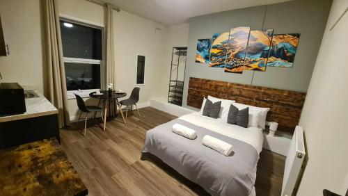 a bedroom with a bed and a table with chairs at City Stays Norwich in Norwich