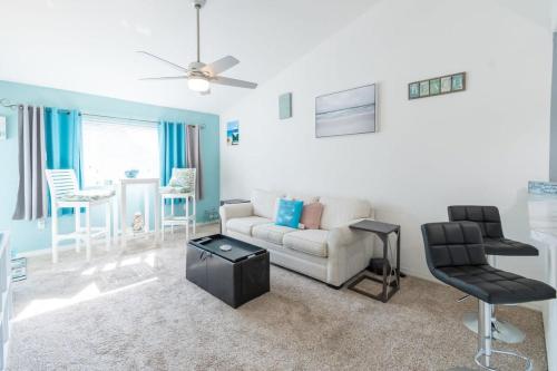 a living room with a couch and a chair at Beachside Oasis at Villages of Seaport in Cape Canaveral