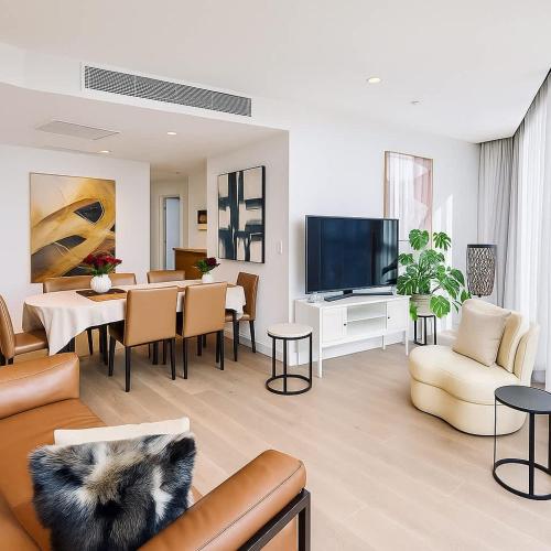 a living room with a couch and a dining room at Skyline Grandeur Executive residence by Ritz in Melbourne