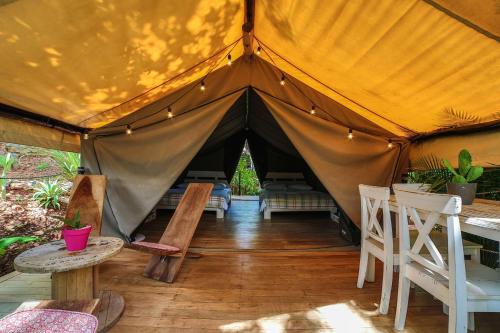 a tent with chairs and tables and a table at Flor y Bambu in Playa Grande