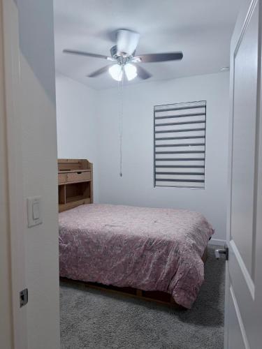a bedroom with a bed and a ceiling fan at Close to Florida Keys in Florida City