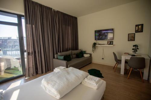 a living room with a couch and a table with a desk at BW Gallery in Belgrade