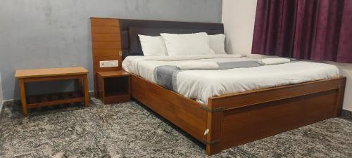 una camera con letto e struttura in legno di Hotel Crossway a Chennai