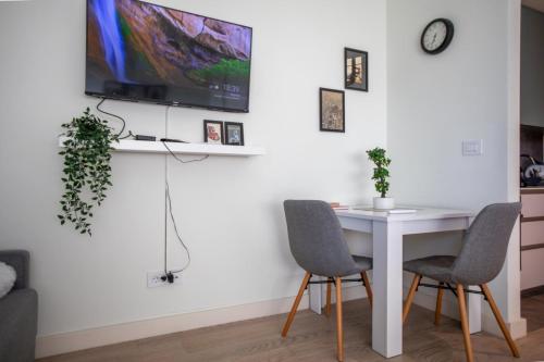 a dining room with a white table and two chairs at BW Gallery in Belgrade