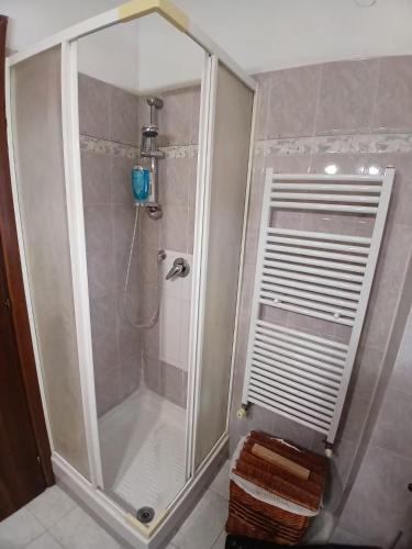 a shower with a glass door in a bathroom at Casa di Viaggiatori Ciampino in Ciampino