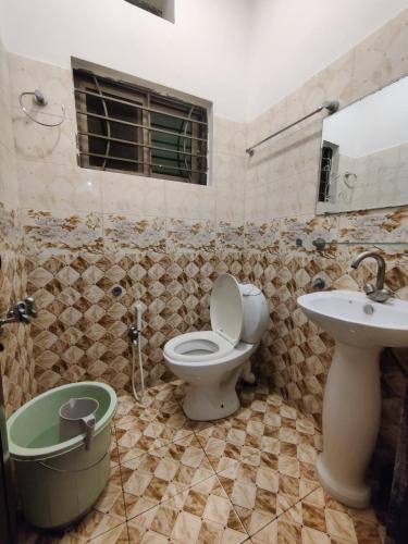 a bathroom with a toilet and a sink at Evergreen Lodge - Unmarried couples not allowed in Rawalpindi