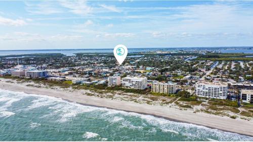 a hot air balloon flying over a beach at Downtown Cocoa Beach Townhome- Walk to Everything in Cocoa Beach
