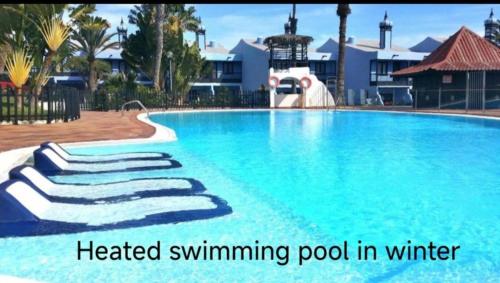a swimming pool at a resort with a heated swimming pool in winter at A Dream On The Beach Sun Club in Playa del Aguila