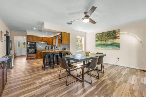 a kitchen and dining room with a table and chairs at Canal-Front Escape w Gazebo Kayaks & Game Room in Cocoa Beach