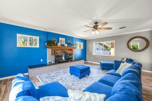 a blue living room with a blue couch and a fireplace at Canal-Front Escape w Gazebo Kayaks & Game Room in Cocoa Beach