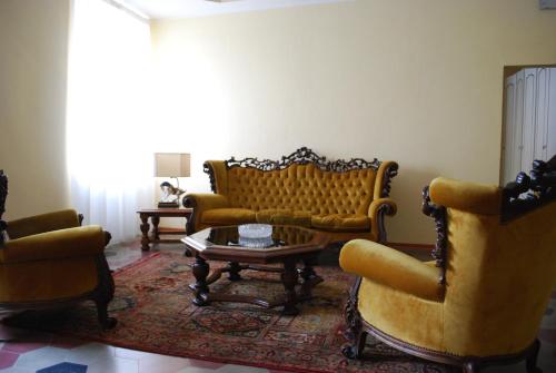 a living room with couches and a table and chairs at Il Convento in Trino