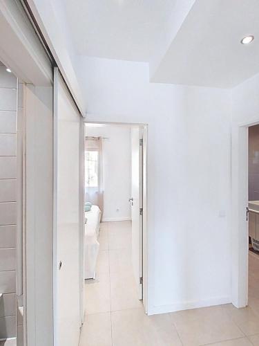 a hallway with white walls and a door to a room at Panorama Old Town sea view Albufeira in Albufeira