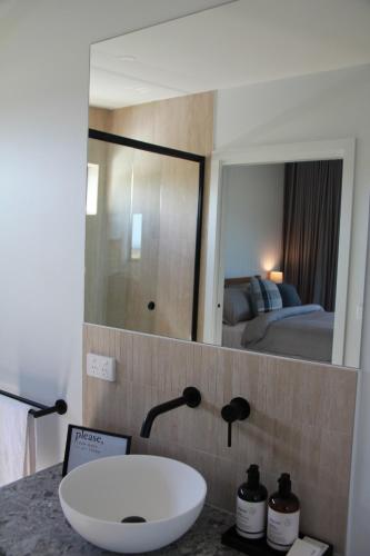 a bathroom with a sink and a mirror at Bellarine Villas in Drysdale
