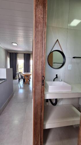 a bathroom with a sink and a mirror on the wall at Flat LITORAL SUL PB CARAPIBUS in Conde