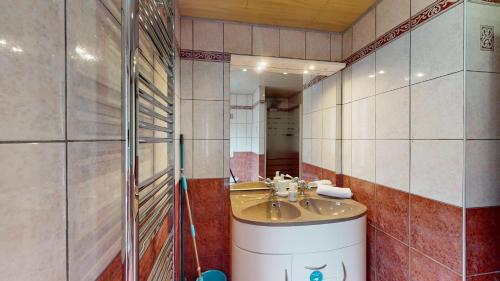 a bathroom with a sink and a mirror at au pied du Haut Koenigsbourg 1 in Saint-Hippolyte