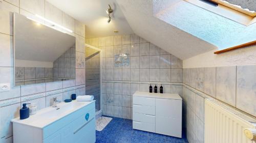 a bathroom with a sink and a mirror at Au pied du Haut Koenigsbourg 2 in Saint-Hippolyte