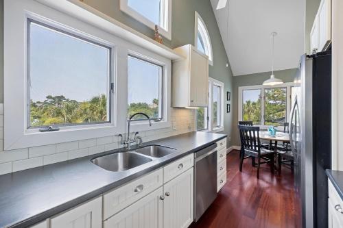 a kitchen with a sink and two windows at RD2224: 2224 Rolling Dune in Seabrook Island