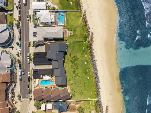 an aerial view of a beach with houses and the ocean at Absolute Beachfront Apartment 2B in Lennox Head