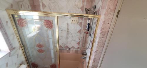 a shower with a glass door in a bathroom at The Cozy Corner in Canoga in Canoga Park