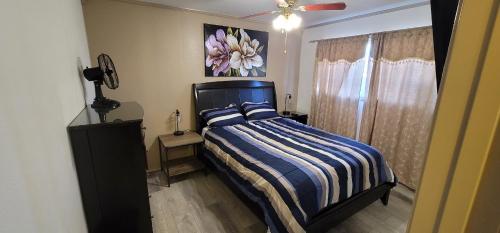 a bedroom with a bed and a painting on the wall at The Cozy Corner in Canoga in Canoga Park