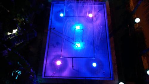a traffic light with purple and green lights at La Fontaine Apartments in Kandia