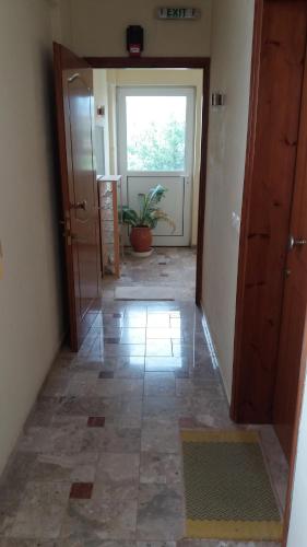 an empty hallway with a door and a window at La Fontaine Apartments in Kandia