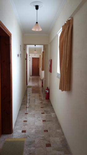 a hallway with a long hallway with a hallwayngthngthngthngthngthngthngth at La Fontaine Apartments in Kandia